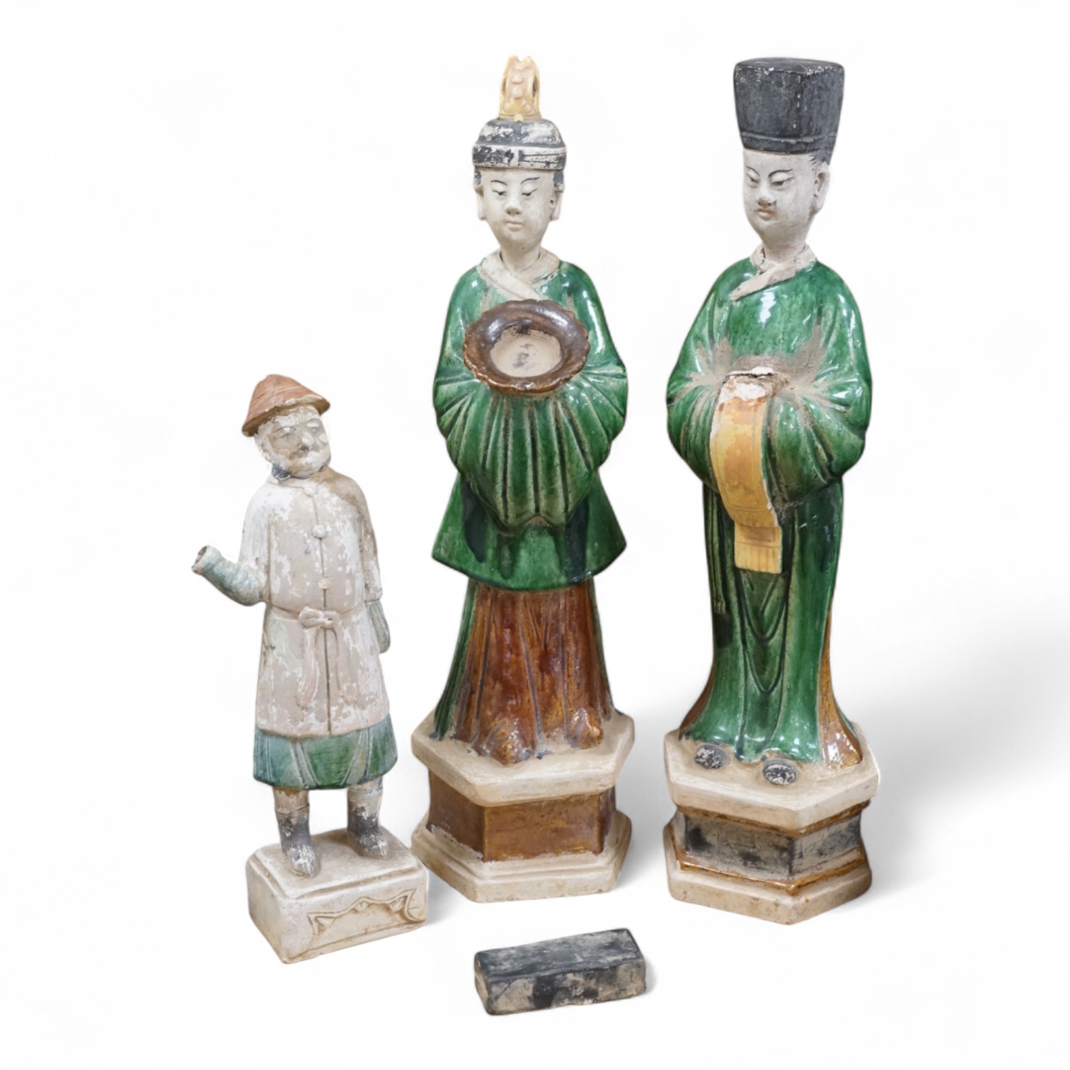 Three Chinese Ming sancai glazed figures of attendants, tallest figure 46cm
